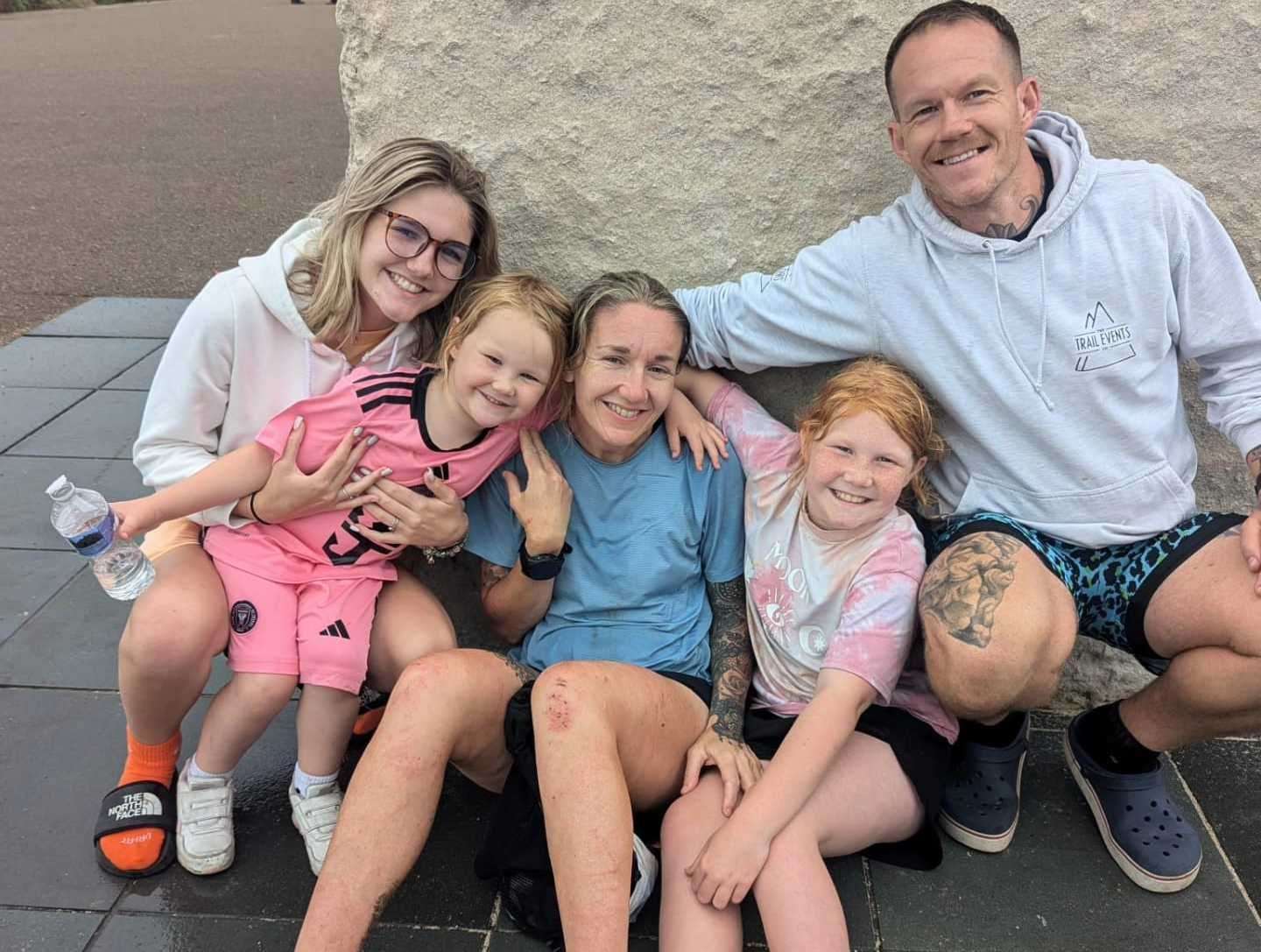 Carly Evans with her family after completing the 127-mile run