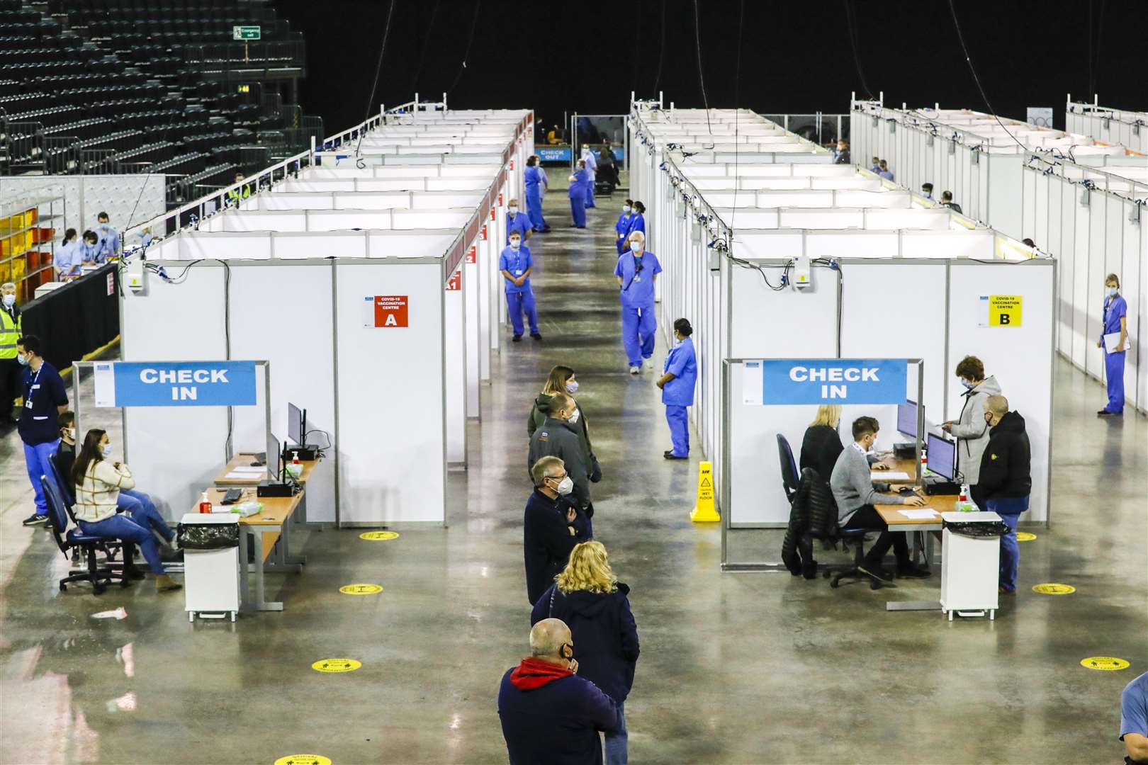 People queue to receive the vaccine at the newly opened Covid-19 vaccination centre in the SSE Arena, Belfast (Liam McBurney/PA)