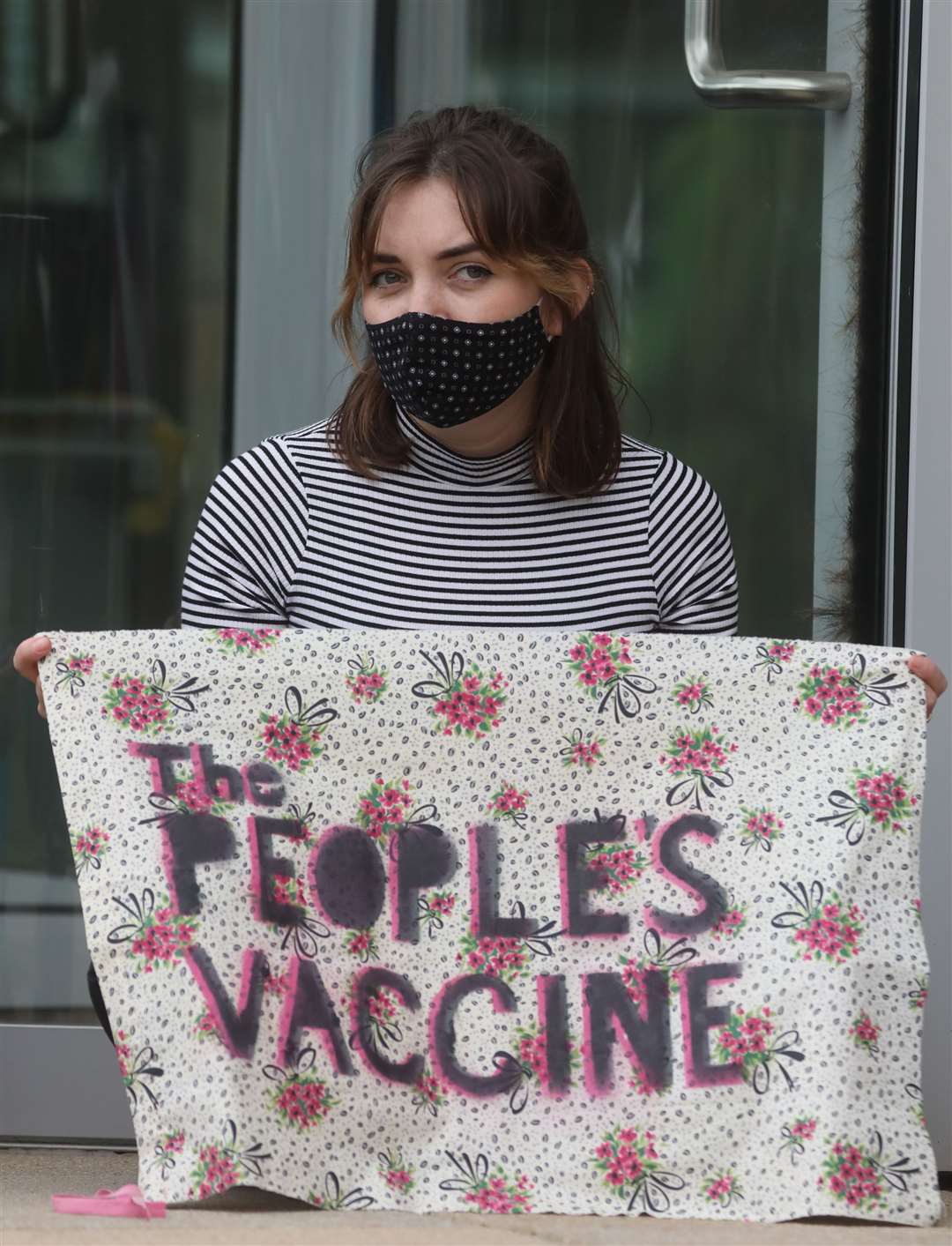 A protester outside AstraZeneca’s HQ in Cambridge (AstraZeneca/PA)