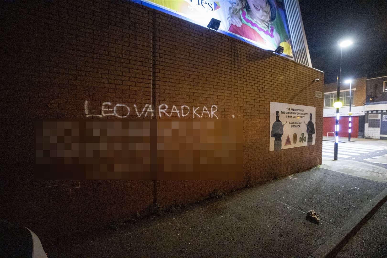 Graffiti with the name of Tanaiste Leo Varadkar and an address on the wall on Belvoir Street off the lower Newtownards Road in east Belfast (Liam McBurney/PA)