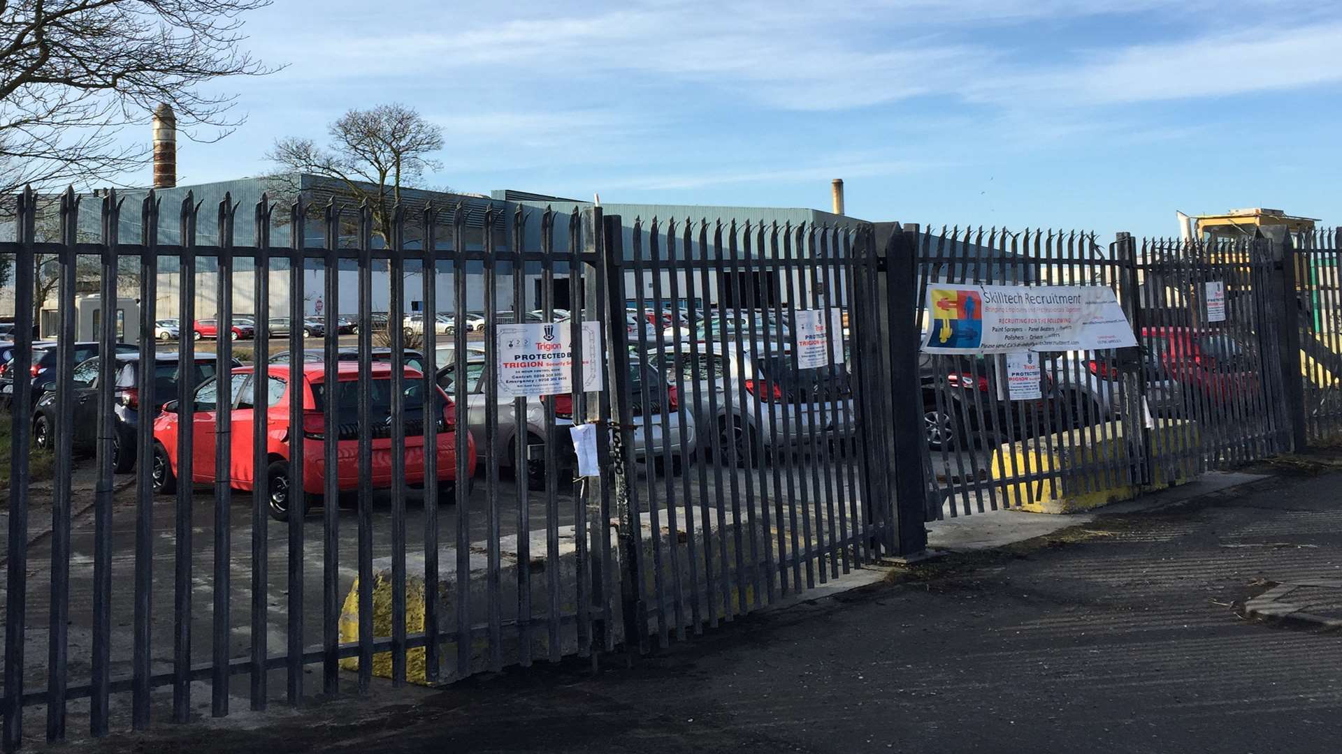 Cars parked behind the gates of Sheerness steel mill