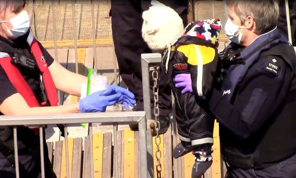 A baby was lifted from a small boat at Dover today by Border Force staff. Picture: Chris Johnson