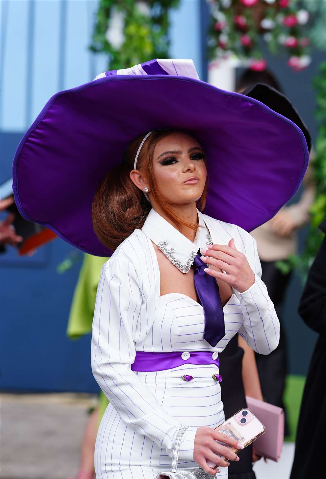 A bright purple tie and diamante detail put a stylish twist on one outfit (Peter Byrne/PA)