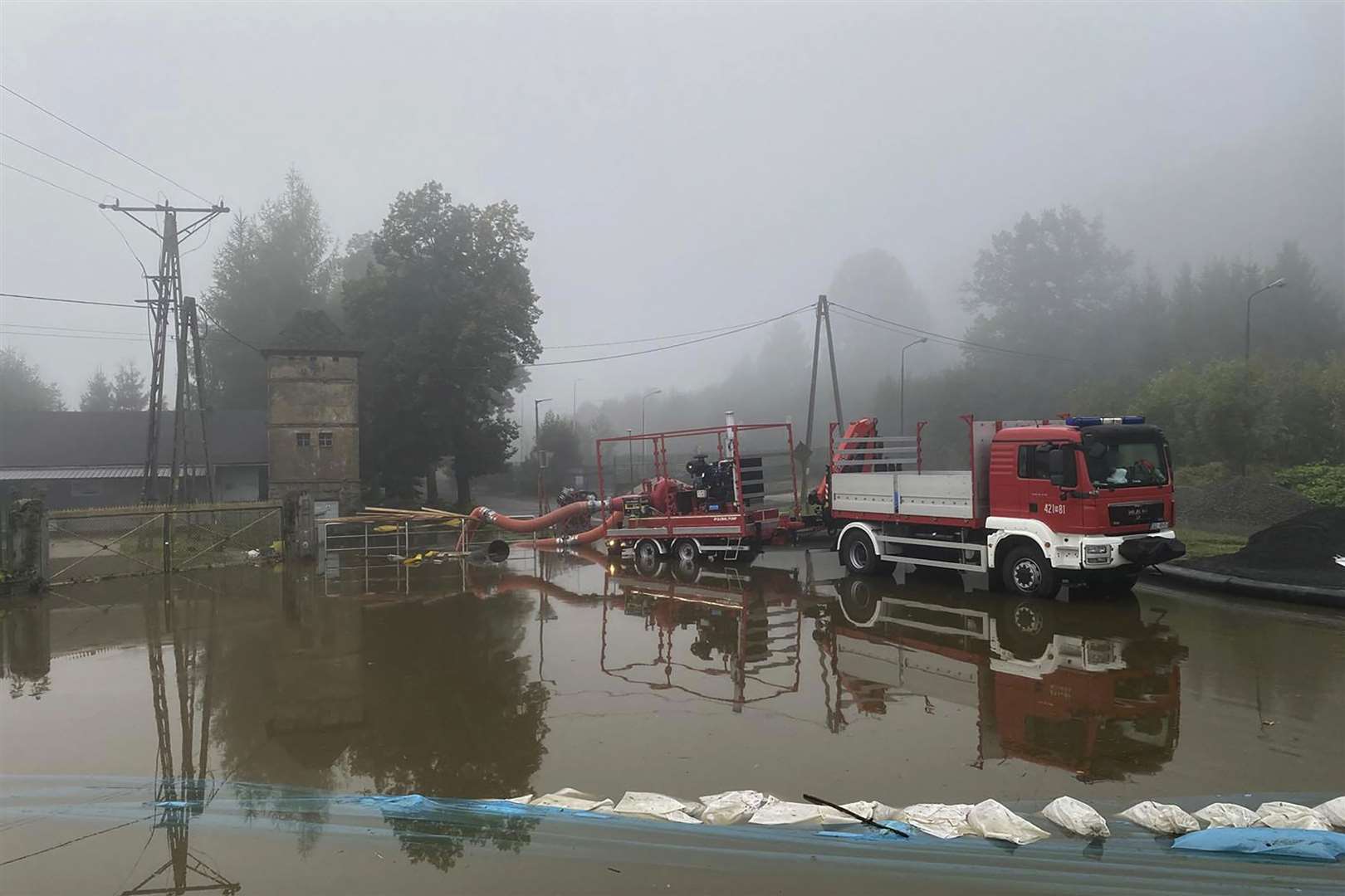 Firefighters pump water and mud from city streets and help clean the city of Glogow that was hit by a high flood wave in south-western Poland (KG PSP via AP/PA)