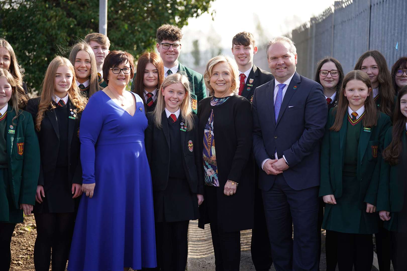 Hillary Clinton, centre, meets Darren Mornin, right, principal of Limavady High School and Rita Moore, left, principal of St Mary’s, and pupils of both schools during a visit to Limavady (Niall Carson/PA)