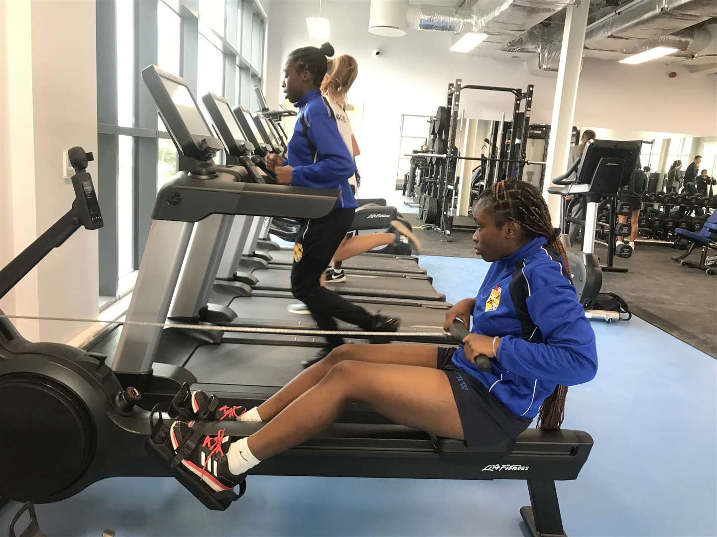 Fitness woman in sportswear outfit training on waterfront harbour