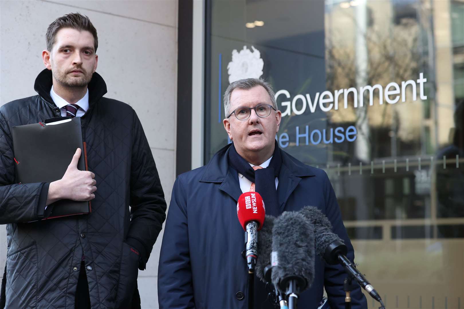 Leader of the DUP Sir Jeffrey Donaldson MP, with Phillip Brett, speaking to the media outside Erskine House, Belfast, following a meeting with Northern Ireland Secretary Chris Heaton-Harris (Liam McBurney/PA)