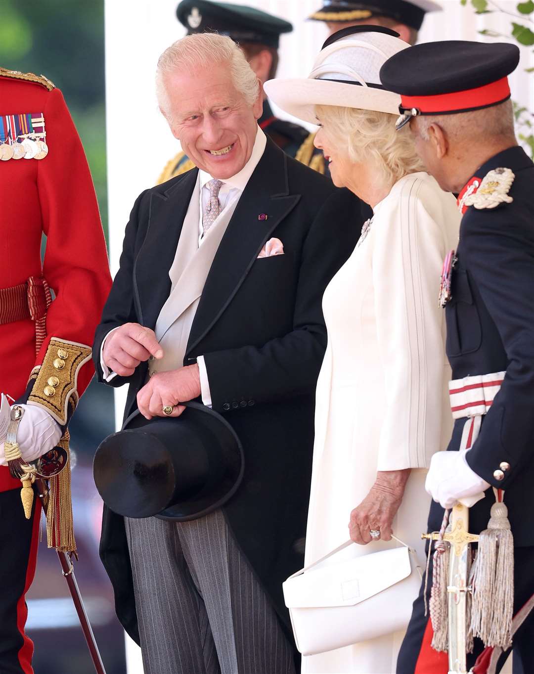 The King smiles as he chats to Camilla ahead of the ceremonial welcome at Horse Guards Parade (Chris Jackson/PA)