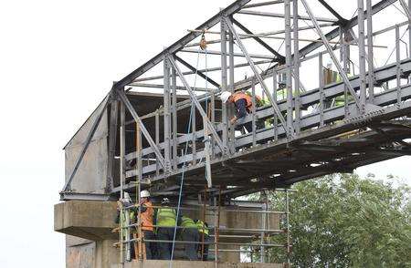 EDF engineers carry out permanent repairs to major electricity cables on a bridge over Dartford Creek