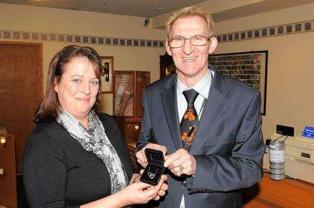 Daphne Nash receiving her necklace from jeweller Denis Burrows