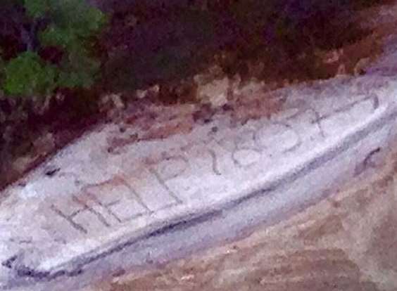 The message Geoff Keys scrawled in the sand. Picture via Queensland police