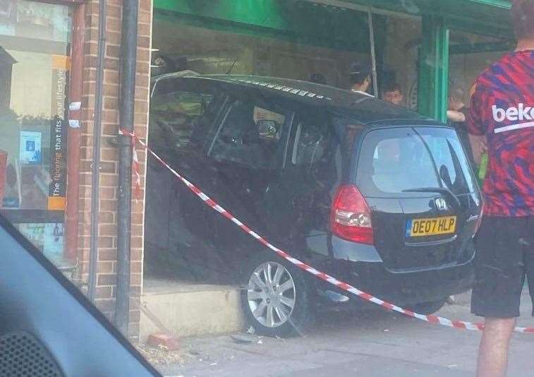 A car has crashed into the front of Papa John's in Twydall