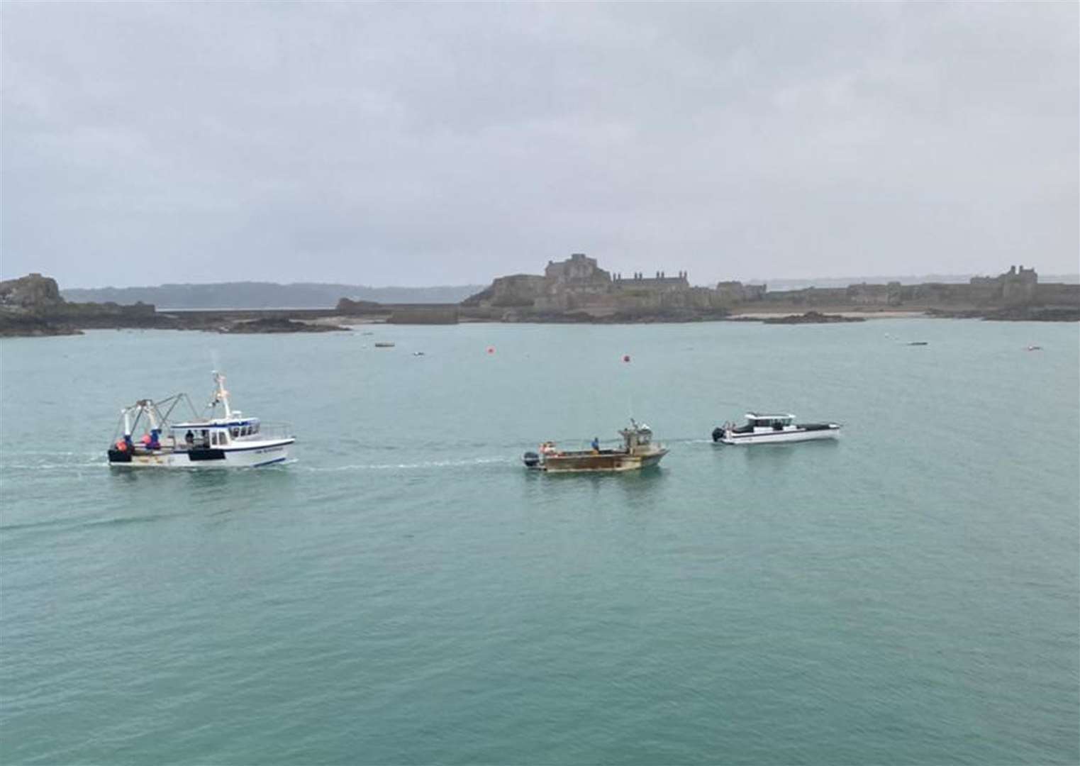 French fishing vessels staging a protest outside the harbour at St Helier, Jersey (Josh Dearing/PA)