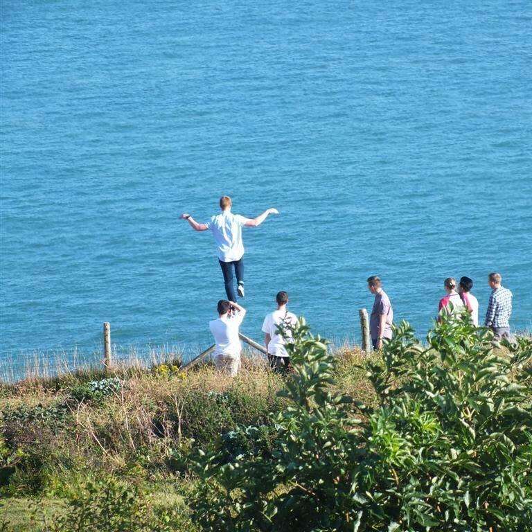 A boy teeters on a post on a cliff edge, 2016. Picture: Maritime and Coastguard Agency.