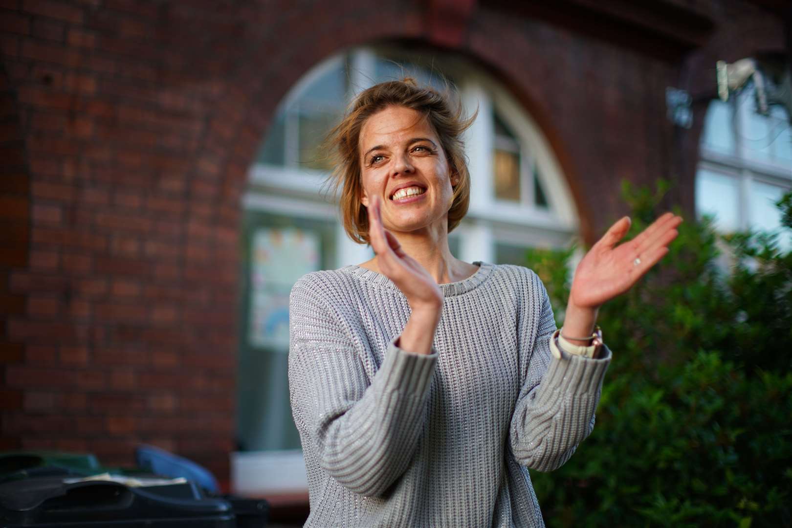 Annemarie Plas, a Dutch national living in south London who created the weekly 8pm Clap for Carers, applauds alongside her neighbours – but she said it would be her final time (Aaron Chown/PA)