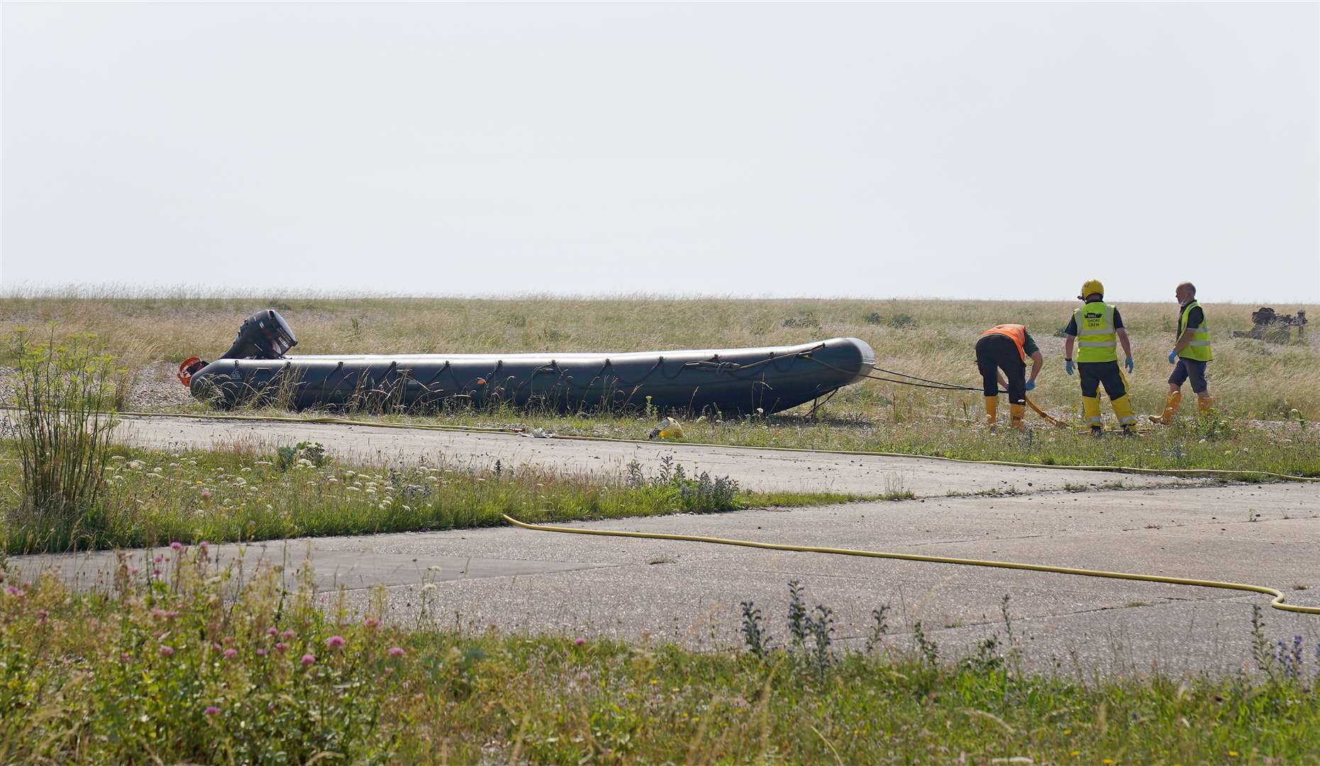 A dinghy used by a group of people thought to be migrants crossing from France is towed from the beach at Dungeness, Kent (Gareth Fuller/PA)