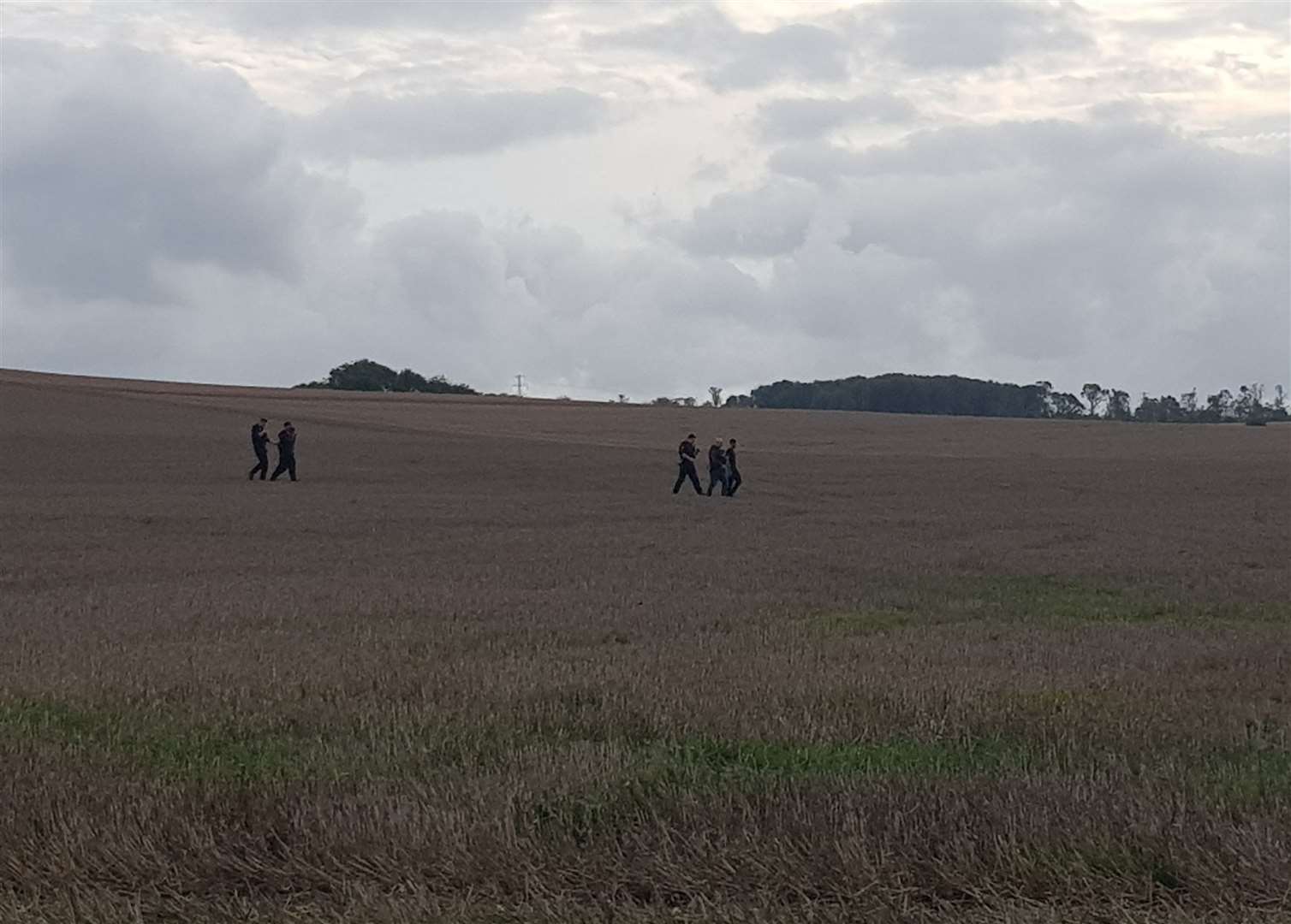 Officers with the suspects on Thursday. Photo Phil Ward