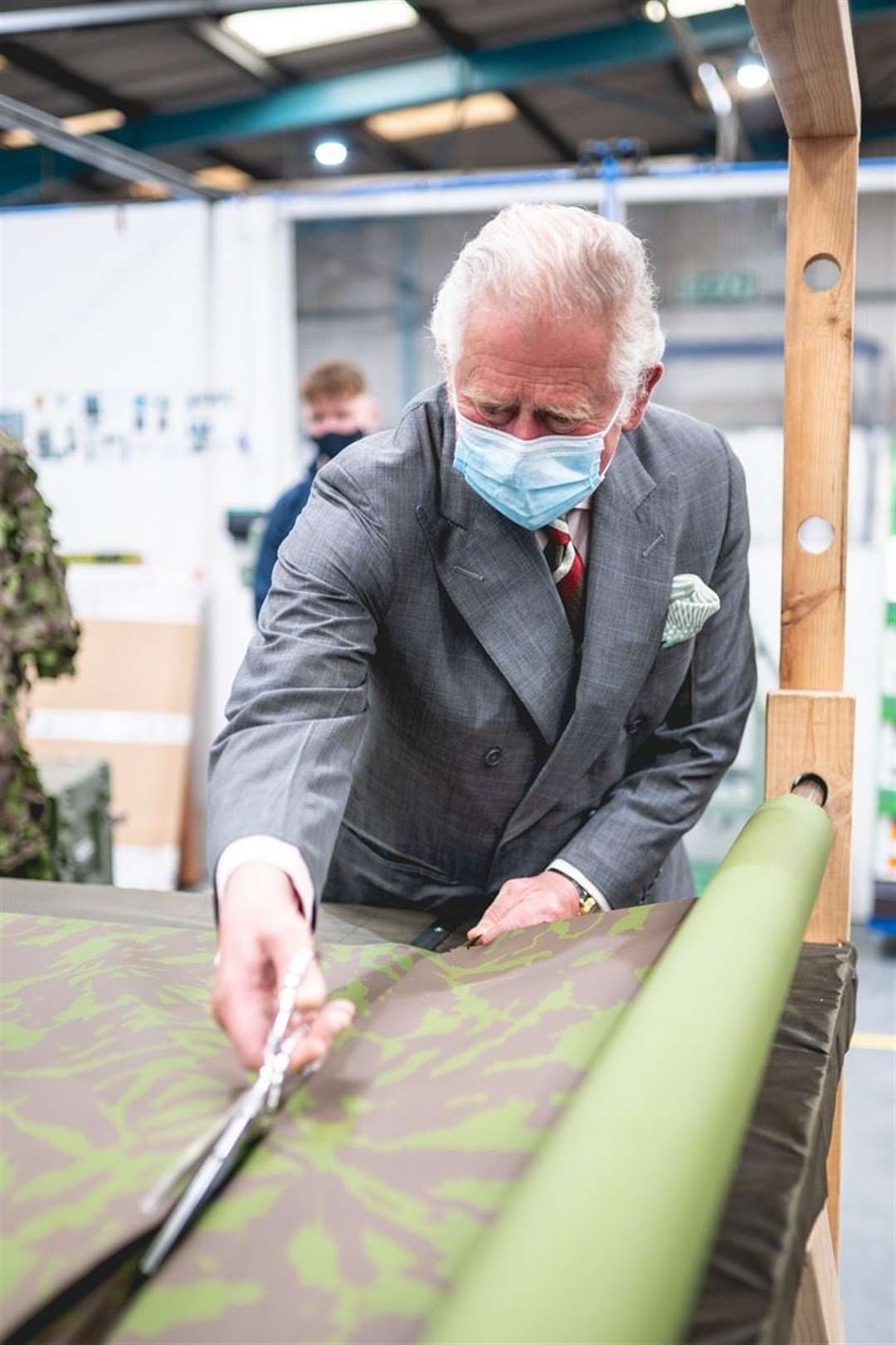 Charles cuts camouflage netting during his visit (BCB International/Jon Plimmer)