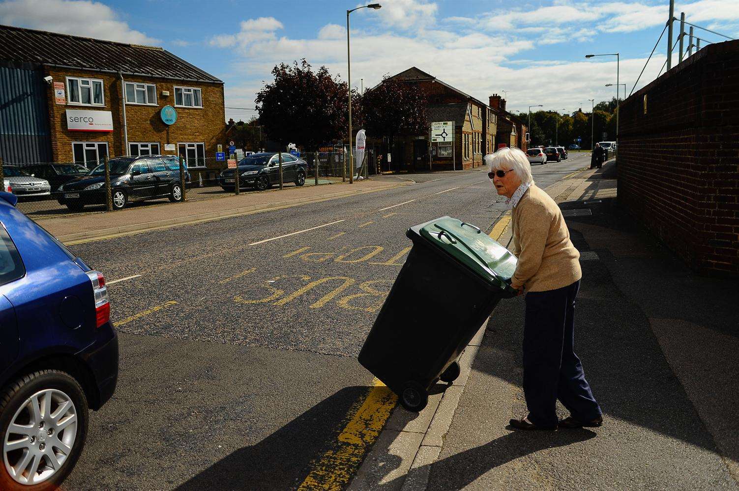 Mrs Niller pushing her wheely bin from her house to Serco bin depot. Picture: Alan Langley