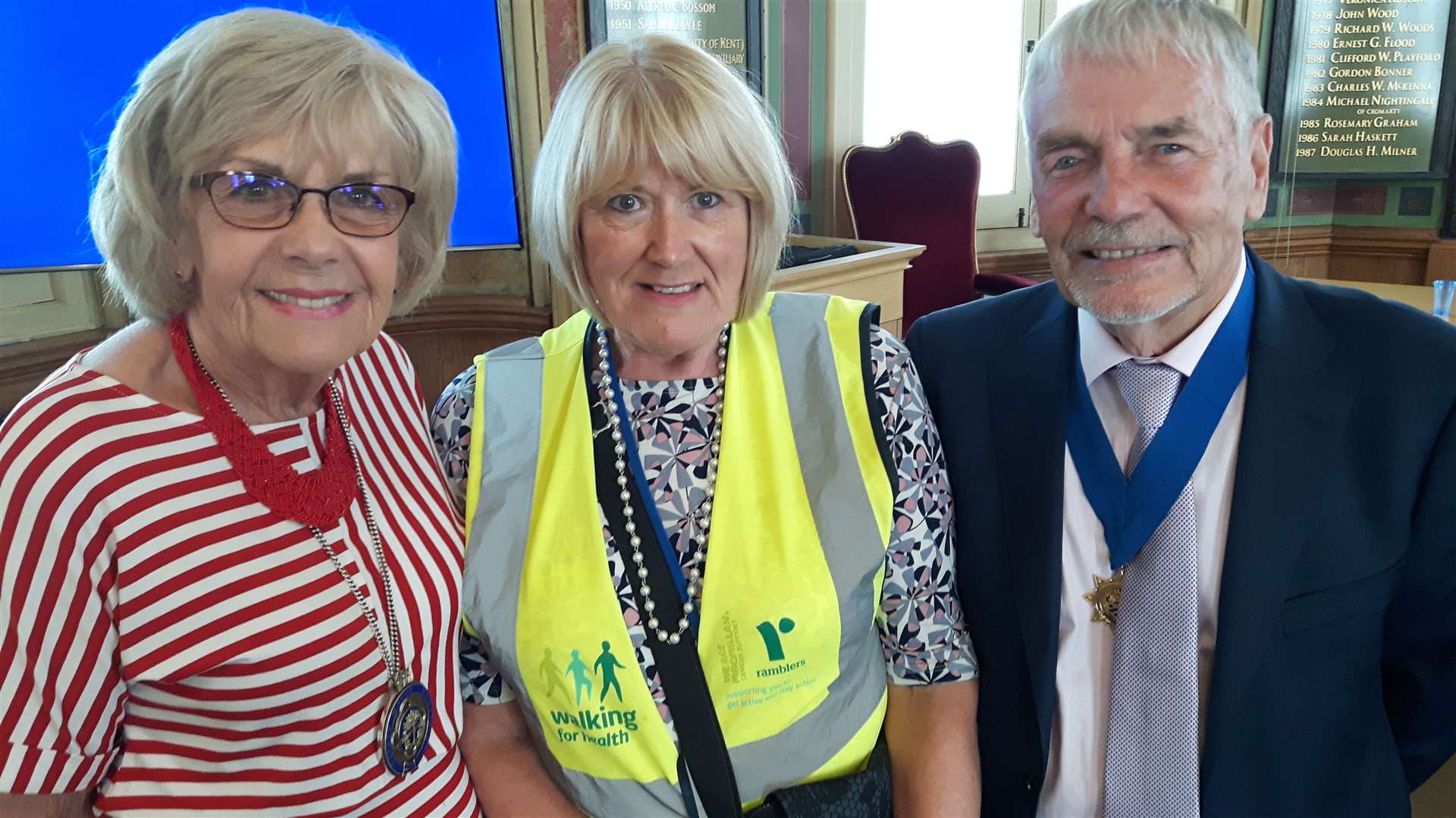 Wendy Hinder, left, hosting a reception for the Walking With Health group in the Town Hall last July, with walk leader Liz Kent, and husband Bob Hinder