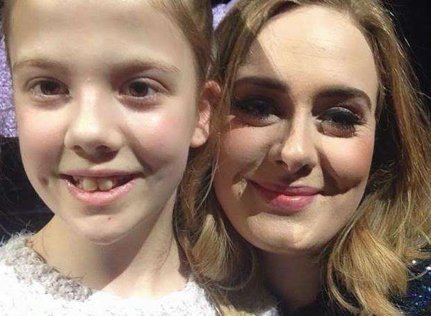 Jasmine, 12, with Adele on the stage at the O2 in London, in front of thousands of fans