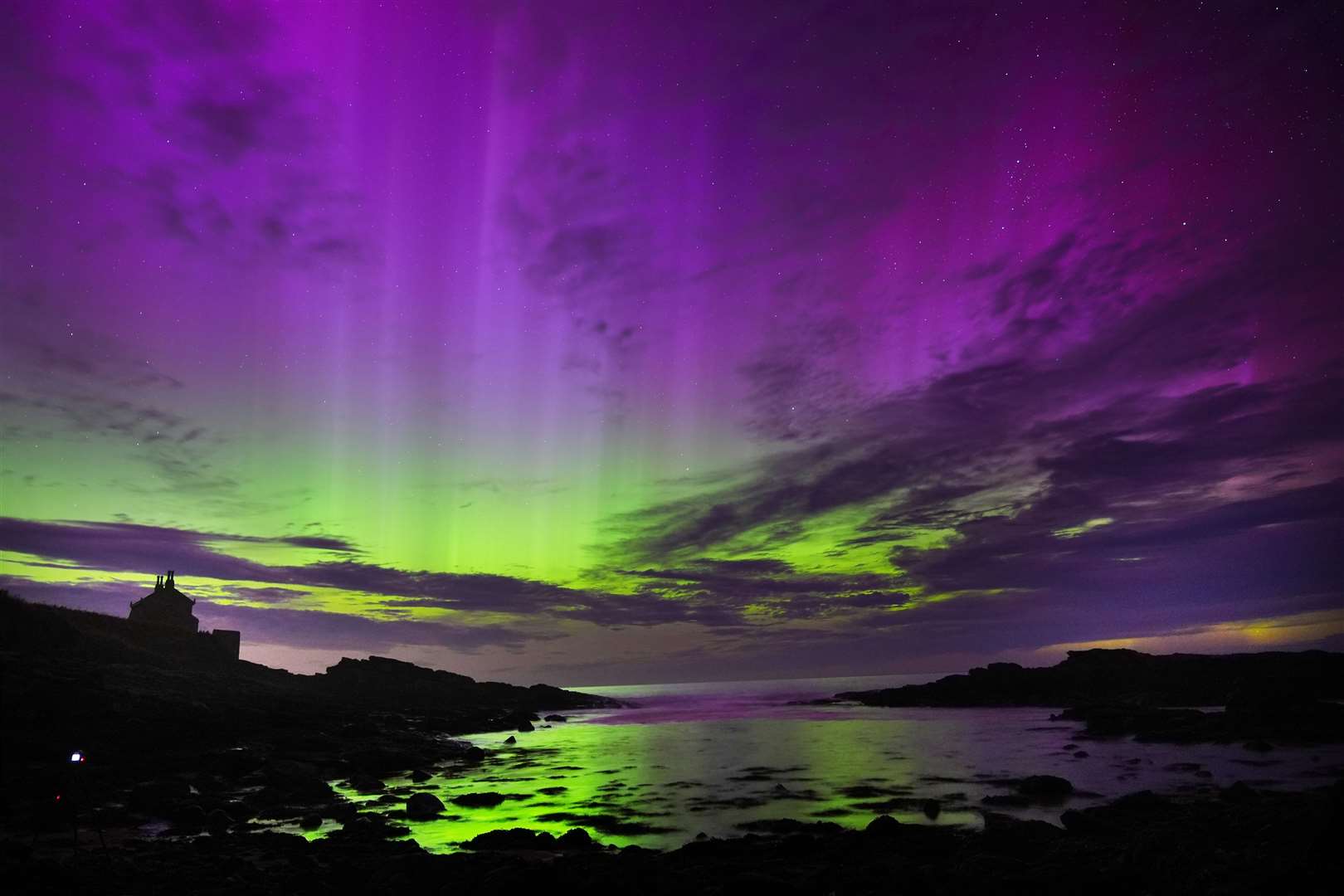 The aurora borealis, also known as the northern lights, fill the sky over the Bathing House in Howick, Northumberland (Owen Humphreys/PA)