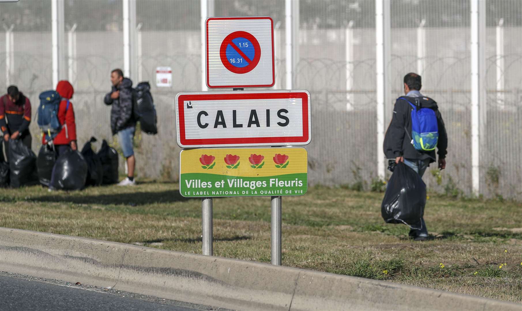 Migrants are moved on from a camp in Calais (Steve Parsons/PA)