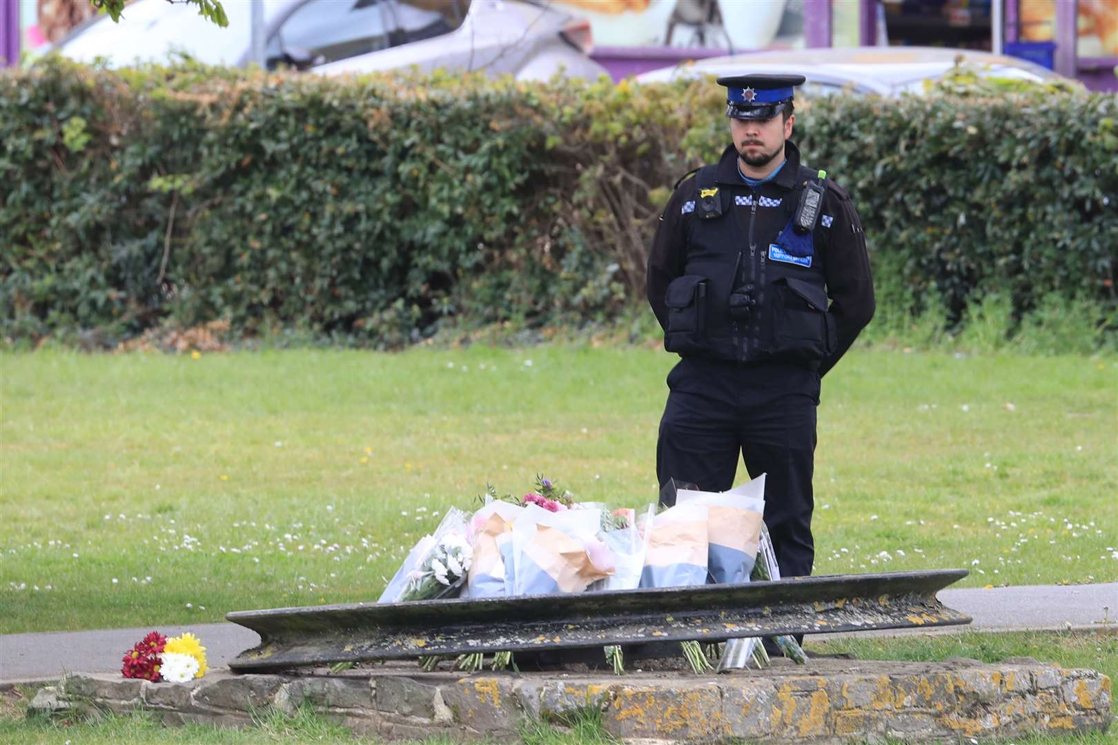 A PCSO looks at flowers and messages left in Aylesham, Kent, for PCSO Julia James (Gareth Fuller/PA)