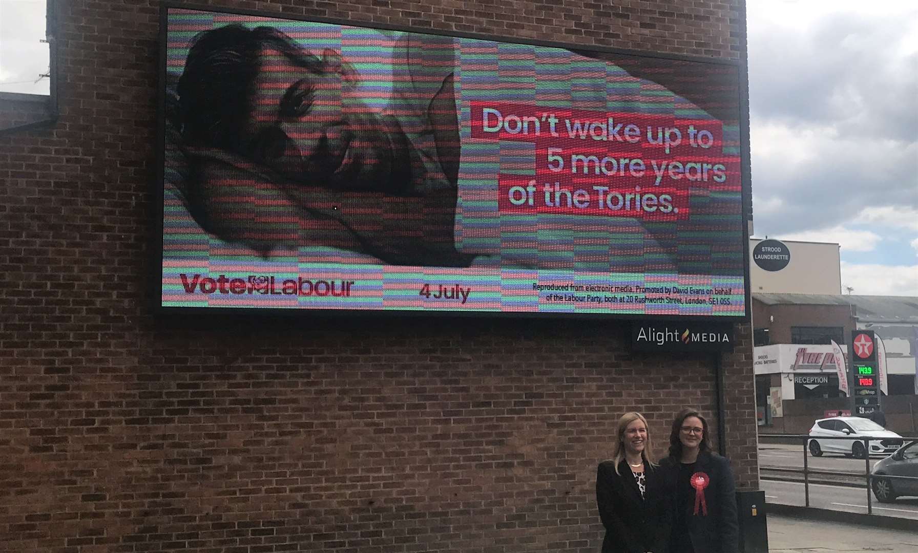 Ellie Reeves, deputy national campaign co-ordinator, and Lauren Edwards, Labour candidate for Rochester and Strood, stand in front of the final Labour Party advert of the general election campaign.