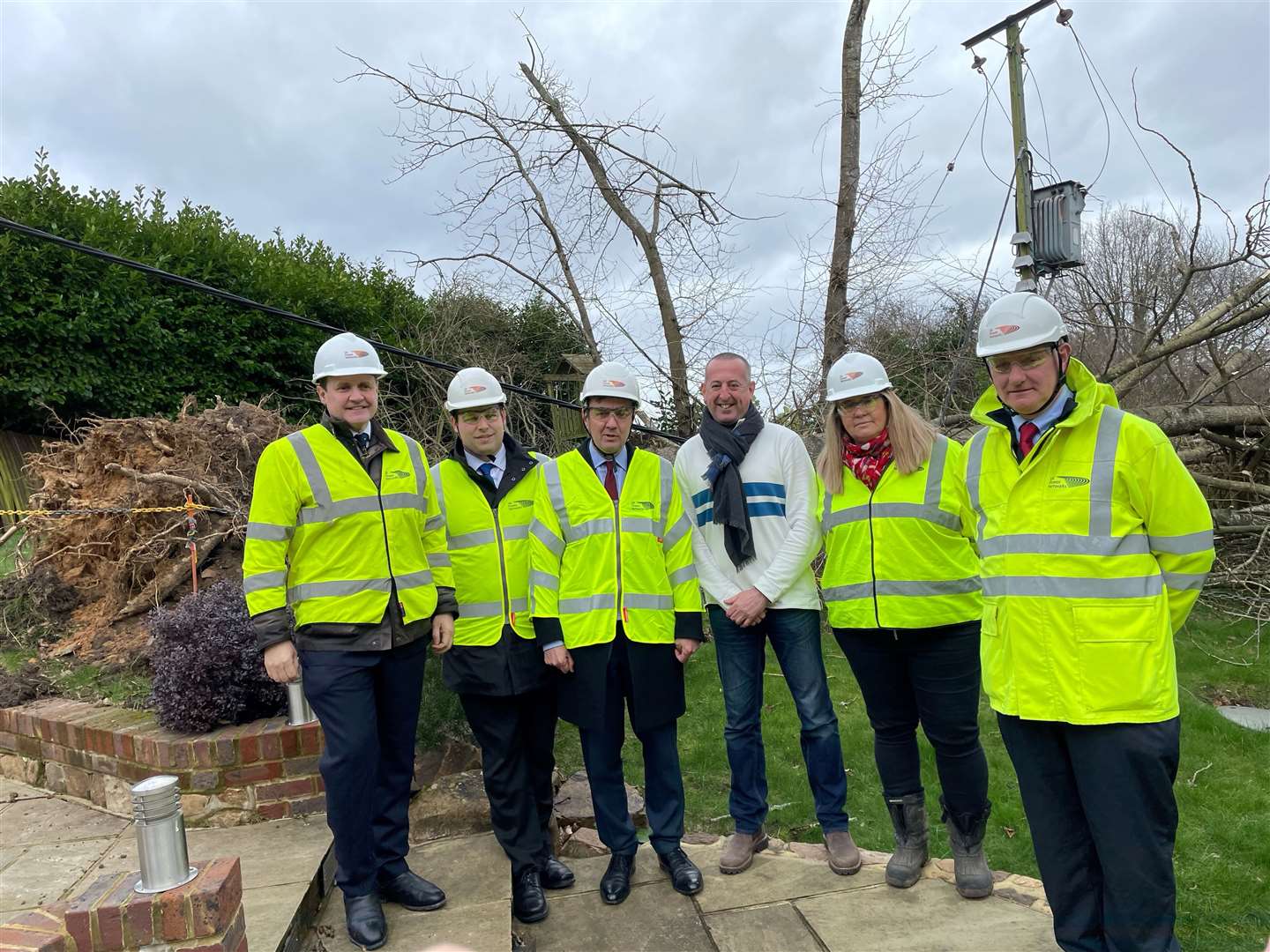 David Thomas (centre) in front of one of the trees in his Kent garden felled by Storm Eunice on Friday (Sophie Wingate/PA)