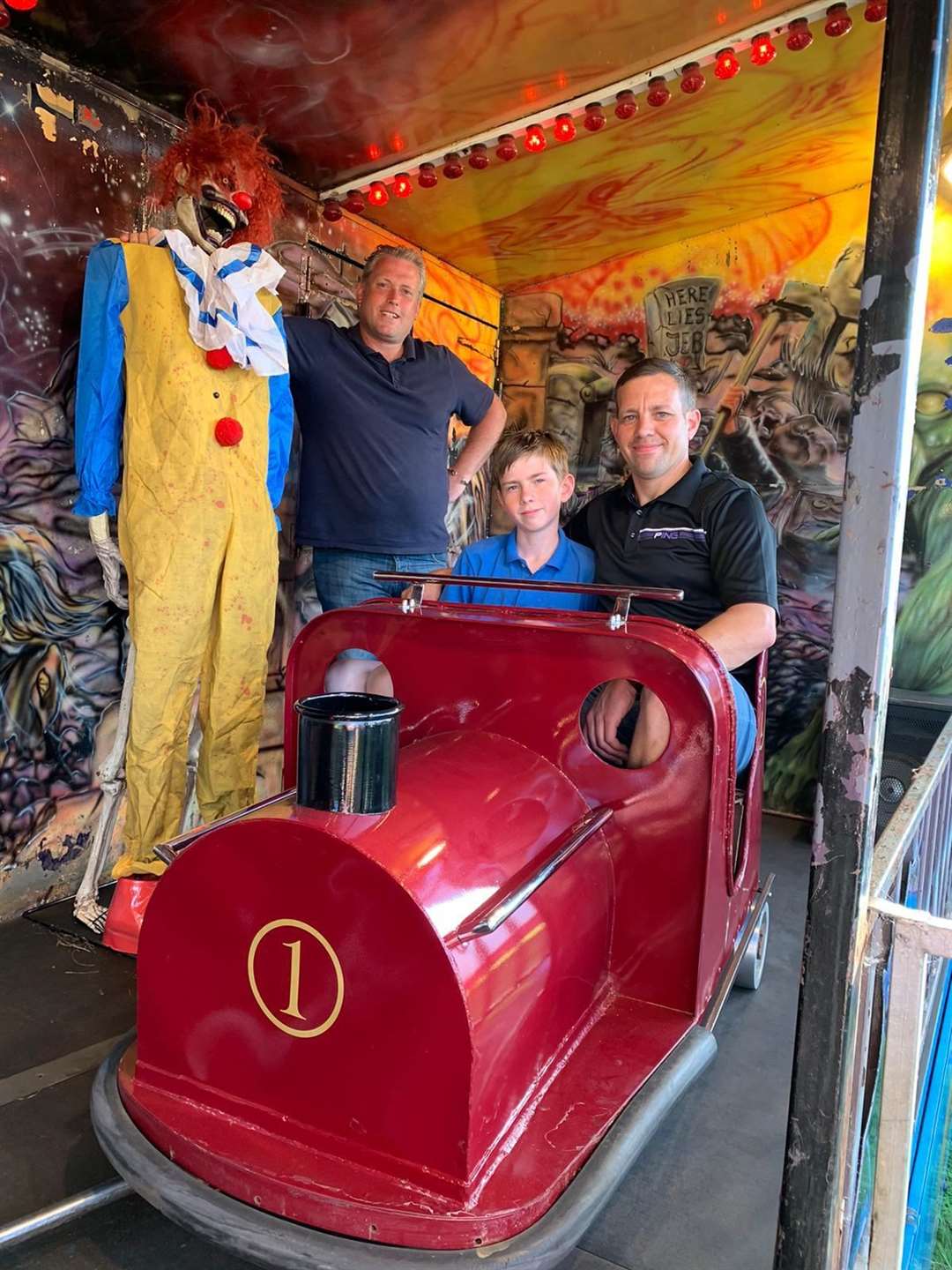 Skeleton staff: Reece Brett, right, pictured with his son Little Reece, and fairground boss Carlos Christian, are looking for a spooky person to join them on the Graveyard Express ghost train visiting Leysdown on the Isle of Sheppey. Picture: Jemma Christian