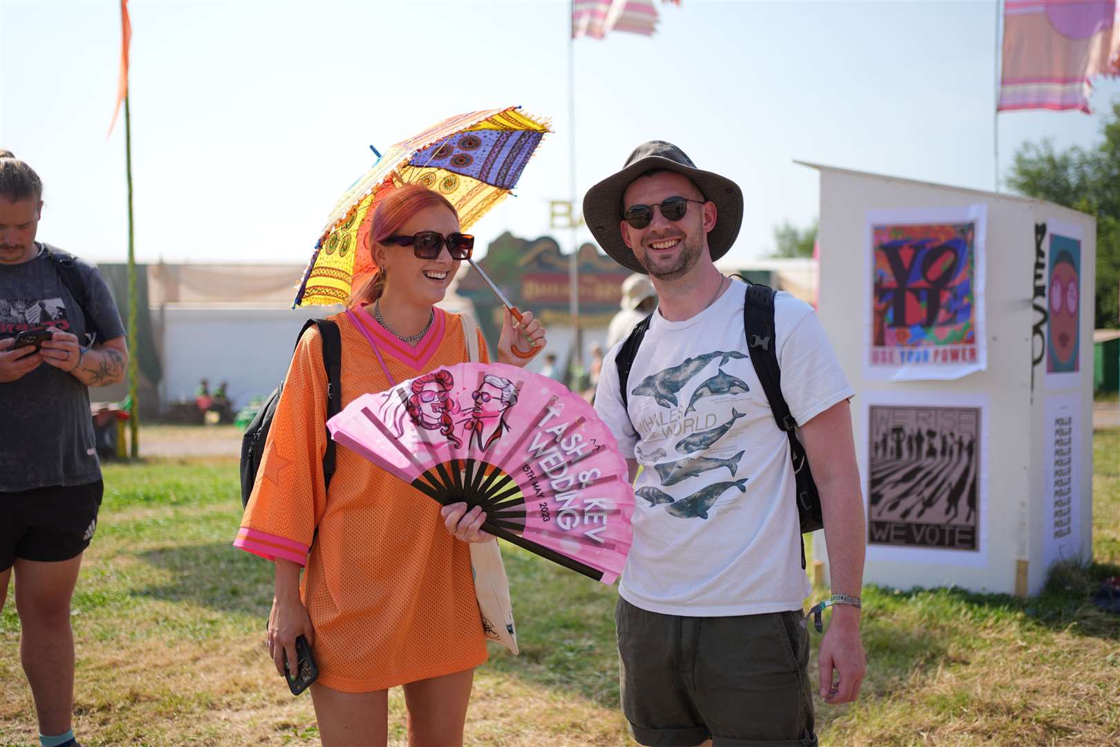 Some festivalgoers arrived prepared with fans and parasols (Yui Mok/PA)