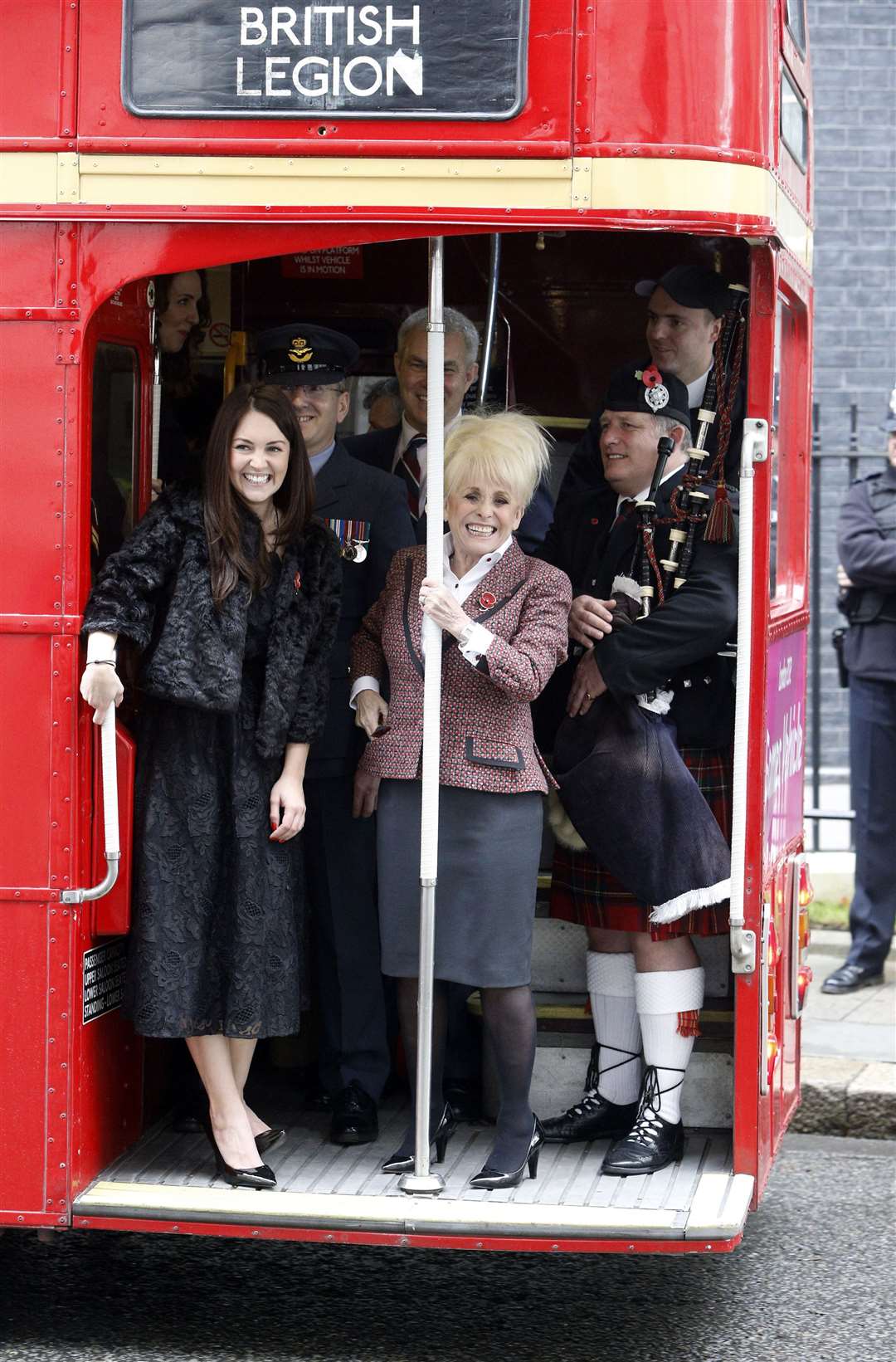 Barbara Windsor on a 1960s Routemaster bus to join military personnel to mark London Poppy Day in 2014 (Steve Parsons/PA)