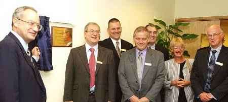 Lord Sainsbury unveils the plaque, watched by Tony McDonald and invited guests