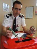 Sgt Gordon Etheridge, from Margate Police Station, with some of the various weapons officers are encouraging the public to put in the red bins at police stations and shops