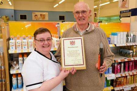 Christine and Derek at Boots, with Derek's leaving certificate and some of his tools.