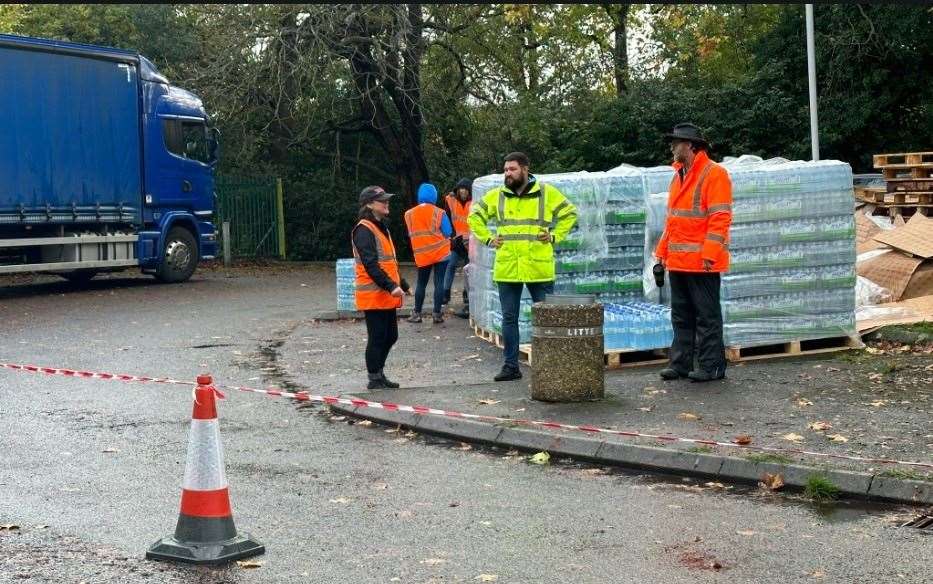 People helping at the water station. Picture: UKNIP