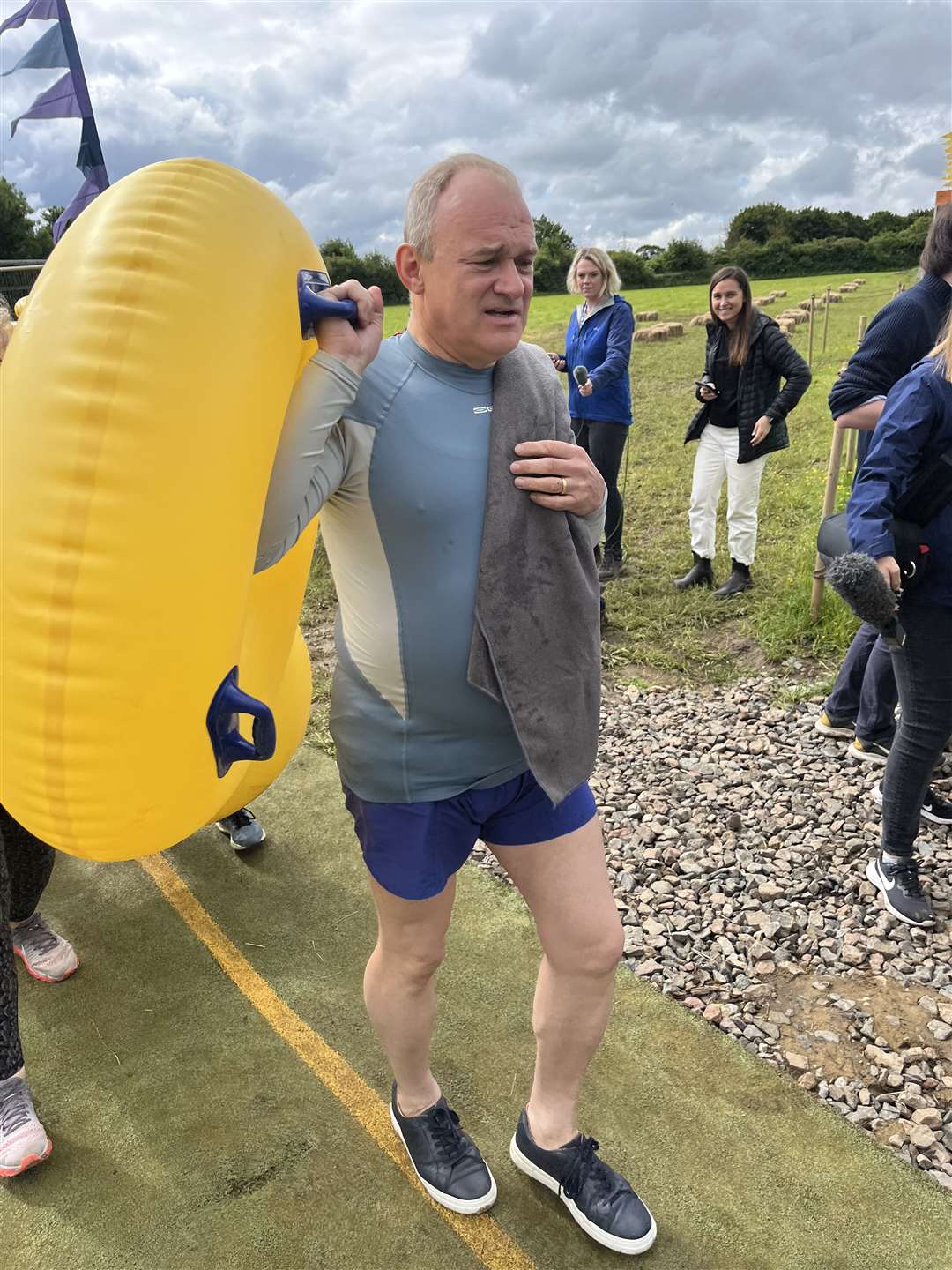 Sir Ed Davey braces himself for a turn on the Ultimate Slip n Slide near Frome, Somerset (Rod Minchin/PA)