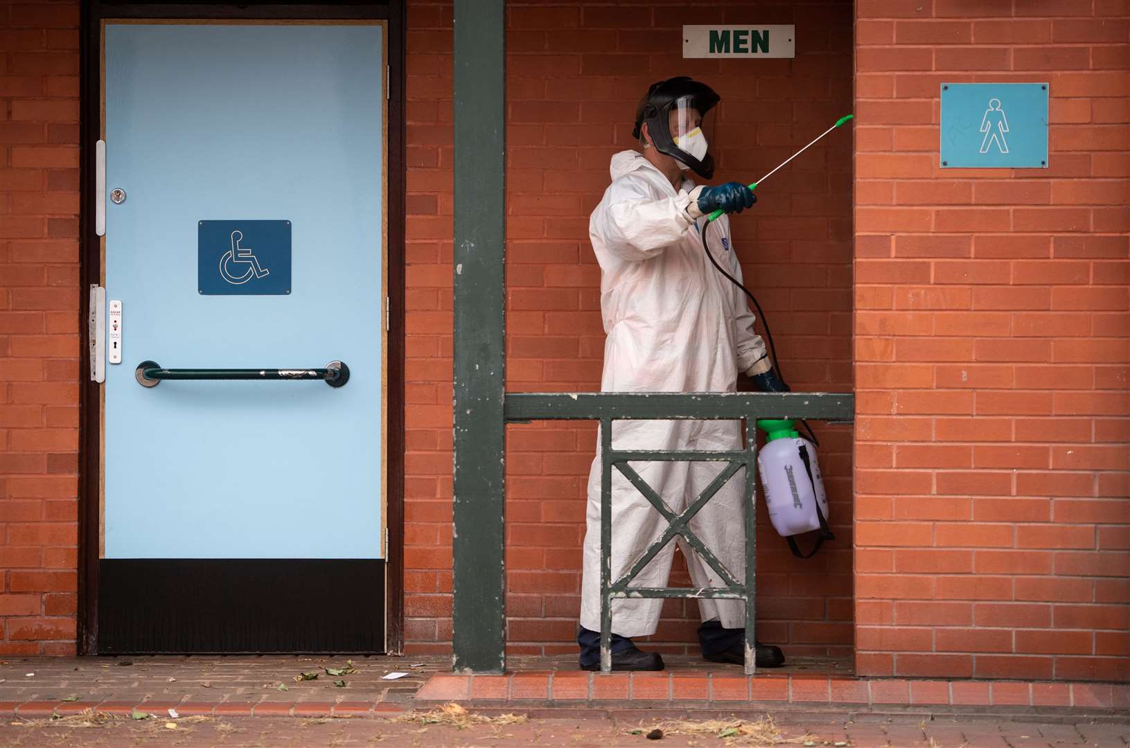 A worker for Leicester City Council disinfects public toilets as the city may be the first UK location to be subjected to a local lockdown (Joe Giddens/PA)