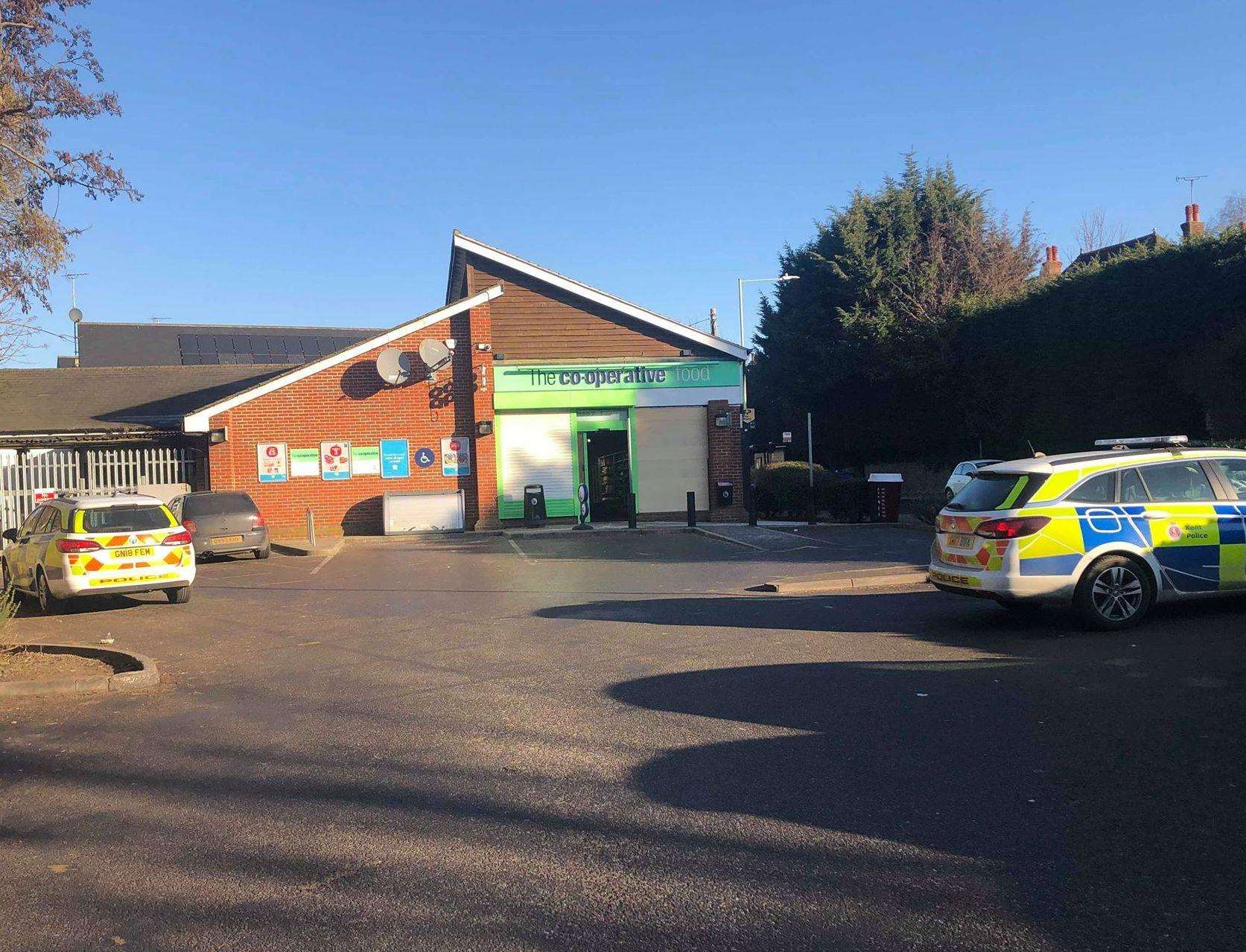 Two police cars outside the Co-op this morning