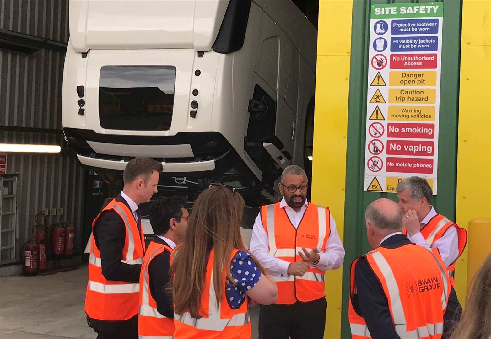 James Cleverly speaking with workers and management at Swain Group in Strood, Rochester, along with Tory parliamentary candidates Kelly Tolhurst, Rehman Chishti, and Nathan Gamester.