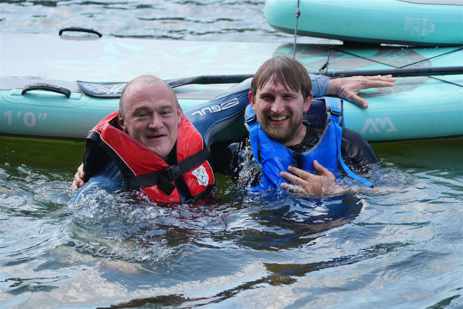 Liberal Democrat leader Sir Ed Davey, left, with the incoming MP for Henley and Thame Freddie van Mierlo paddling in the River Thames at Goring on the campaign trail (Jonathan Brady/PA)