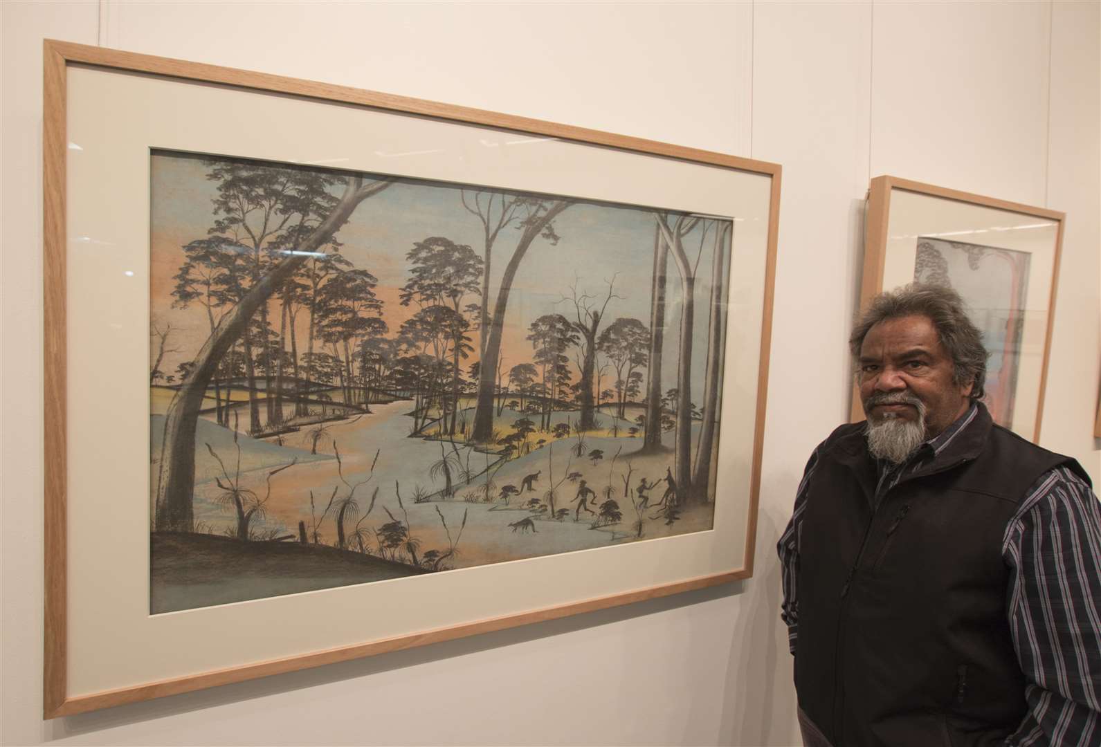 Goreng Noongar elder Ezzard Flowers in 2015, with artwork by Barry Loo (Brad Coleman/John Curtin Gallery/PA)