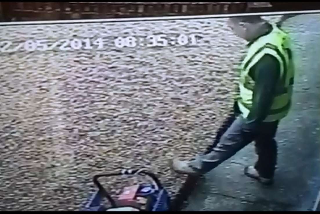 Another builder wipes his muddy boots on the edge of a path