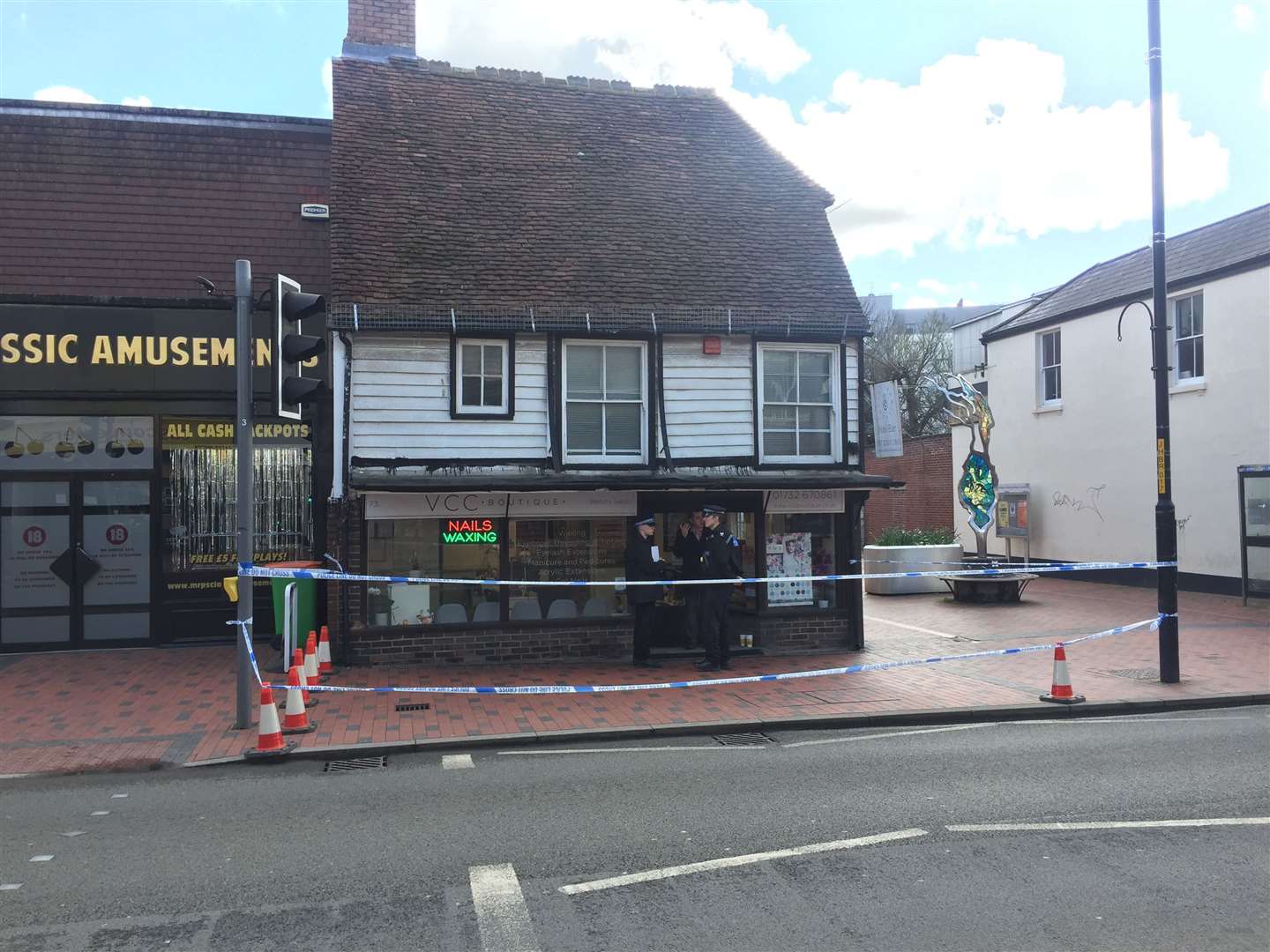 Police outside the nail bar in Tonbridge High Street after the alleged attack