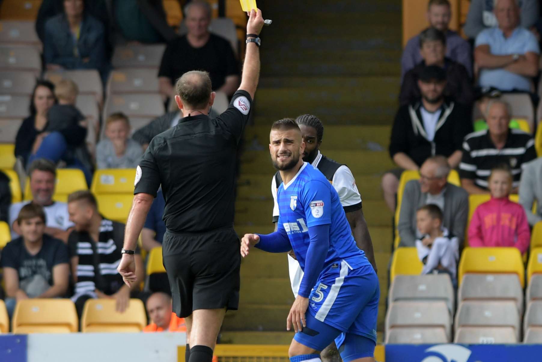 Max Ehmer is booked by referee Carl Boyseon Picture: Barry Goodwin