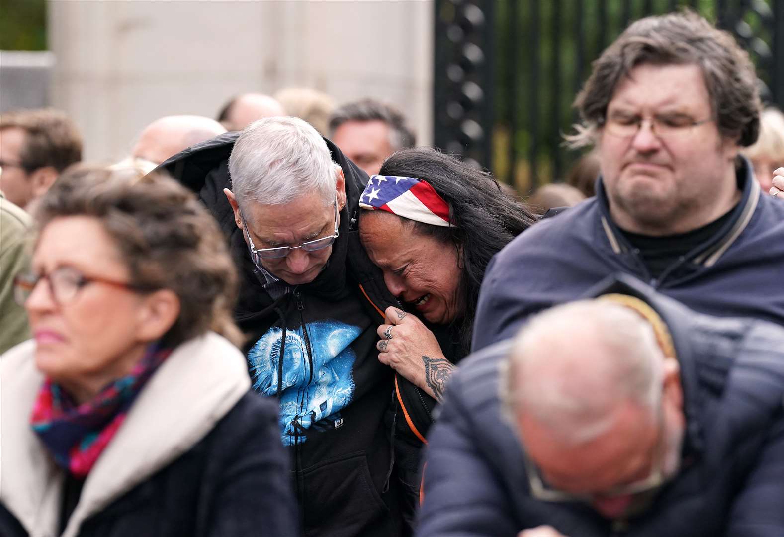 Members of the public on the Mall listen to the state funeral (Tim Goode/PA)