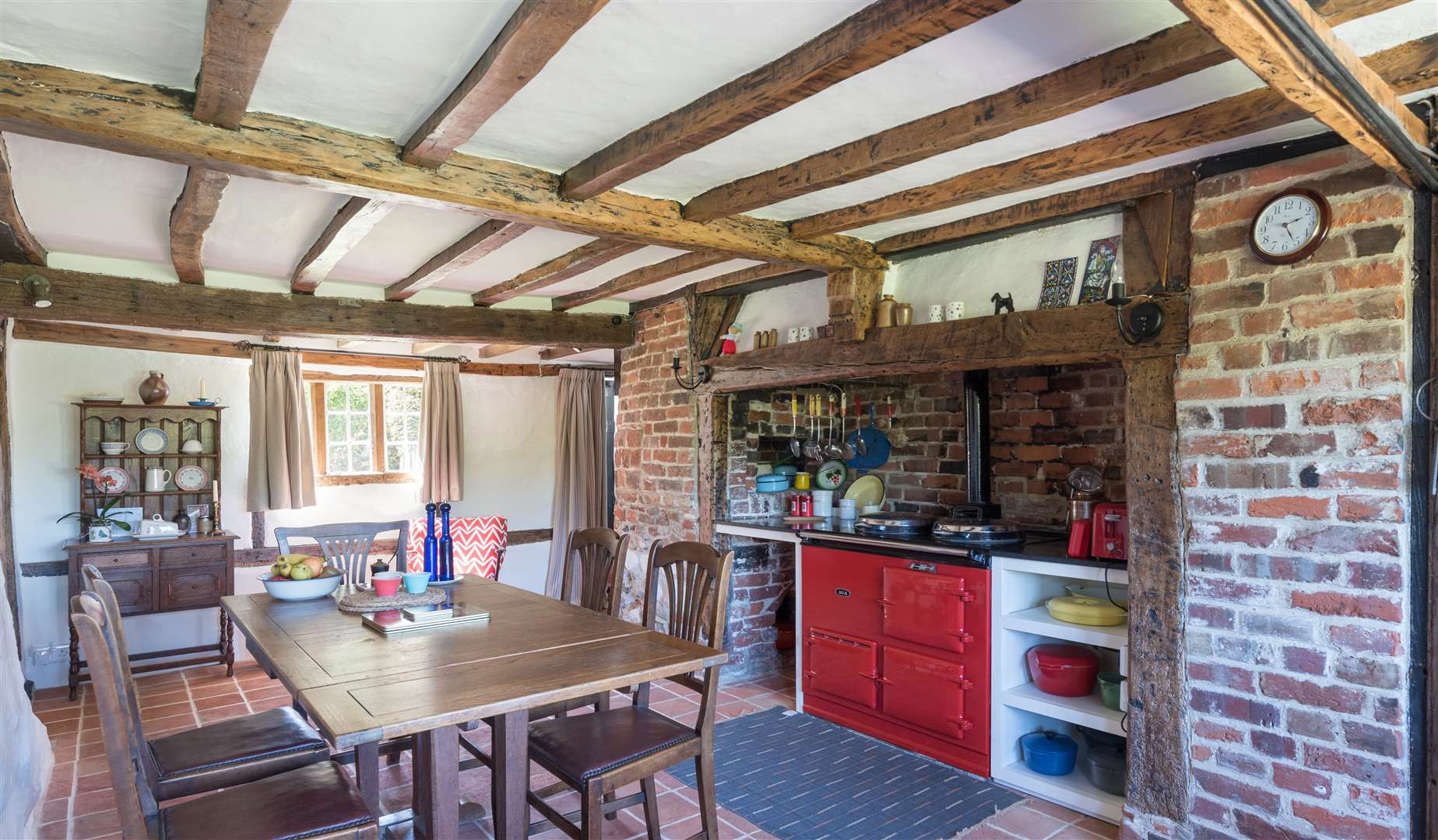 A pillar-box red Aga is central to the kitchen