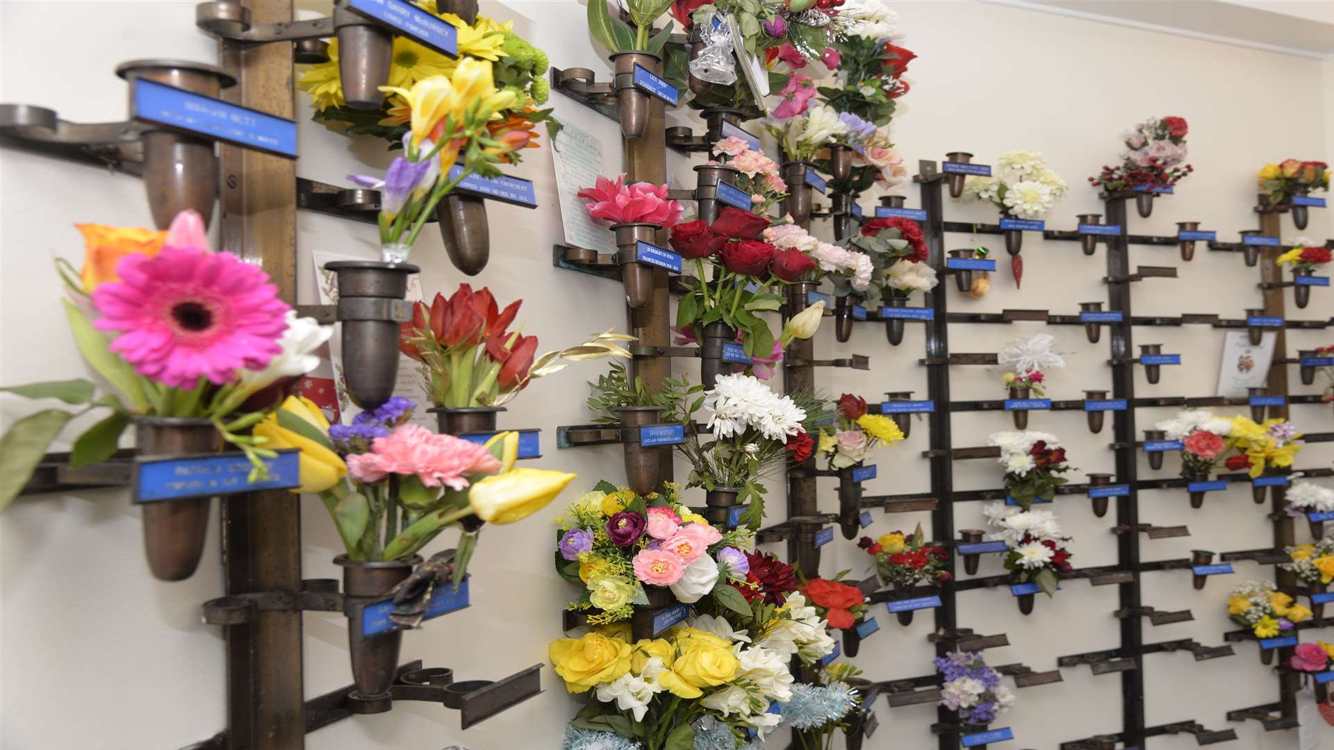 The name plates and vases on the wall of the memorial chapel at Barham Crematorium. Picture: Ruth Cuerden