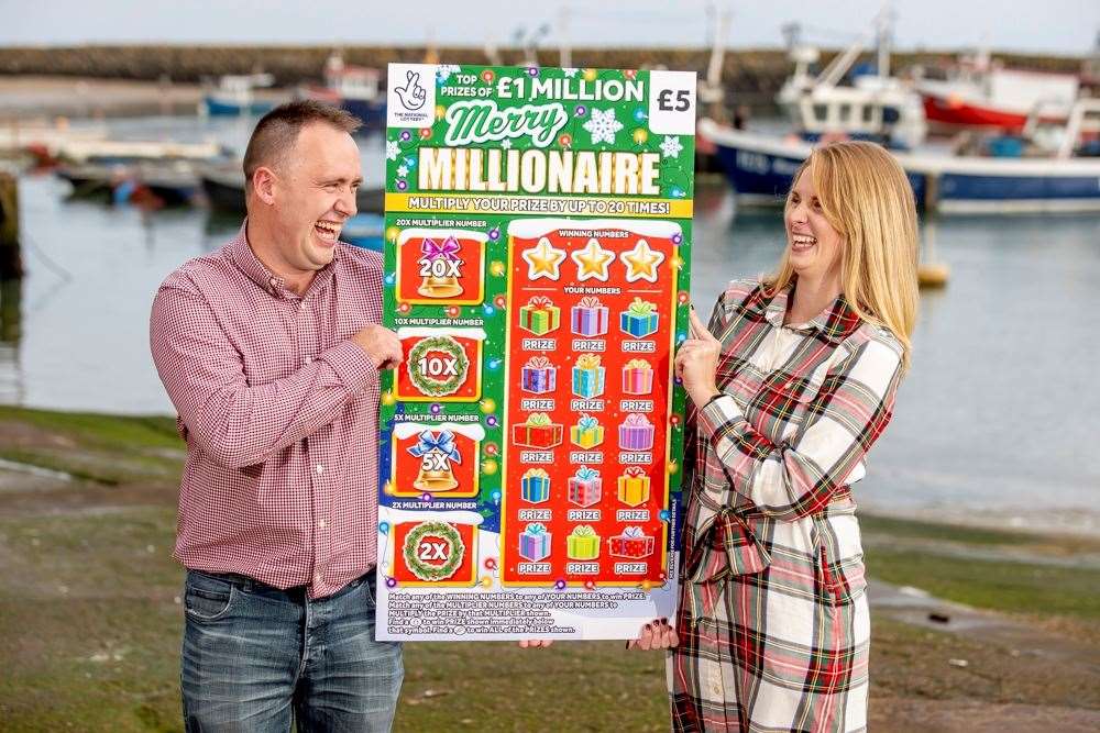 Luke and Alison with a replica winning scratchcard. Picture: Allwyn